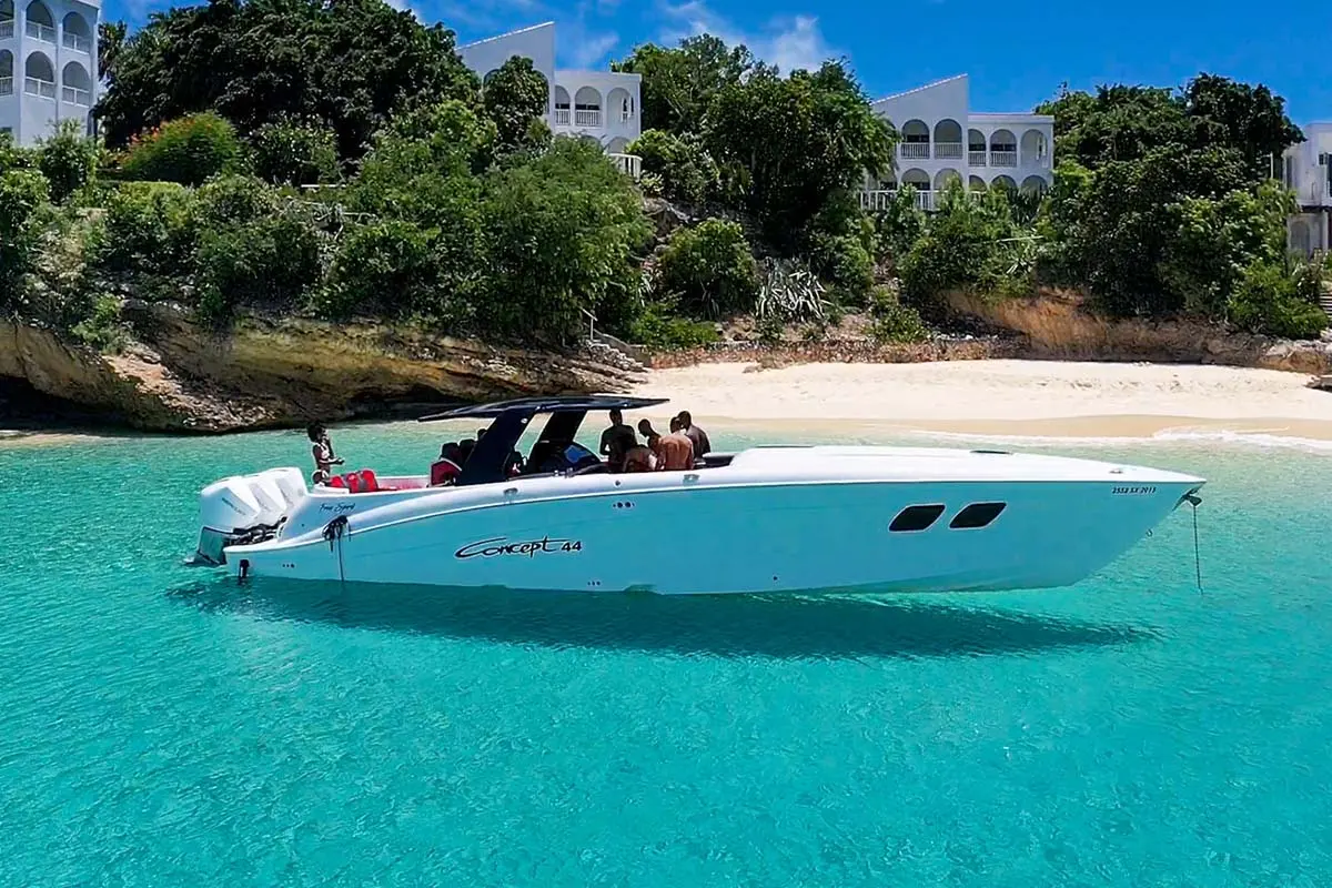 The Concept 44 powerboat we charter for private crossings, anchored in clear turquoise water off a St Barth beach